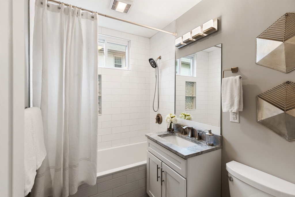 47 Fuller Road, Unit 47 Watertown, MA 02472 - Photo 11 of 21 a bathroom with a granite countertop sink and a mirror