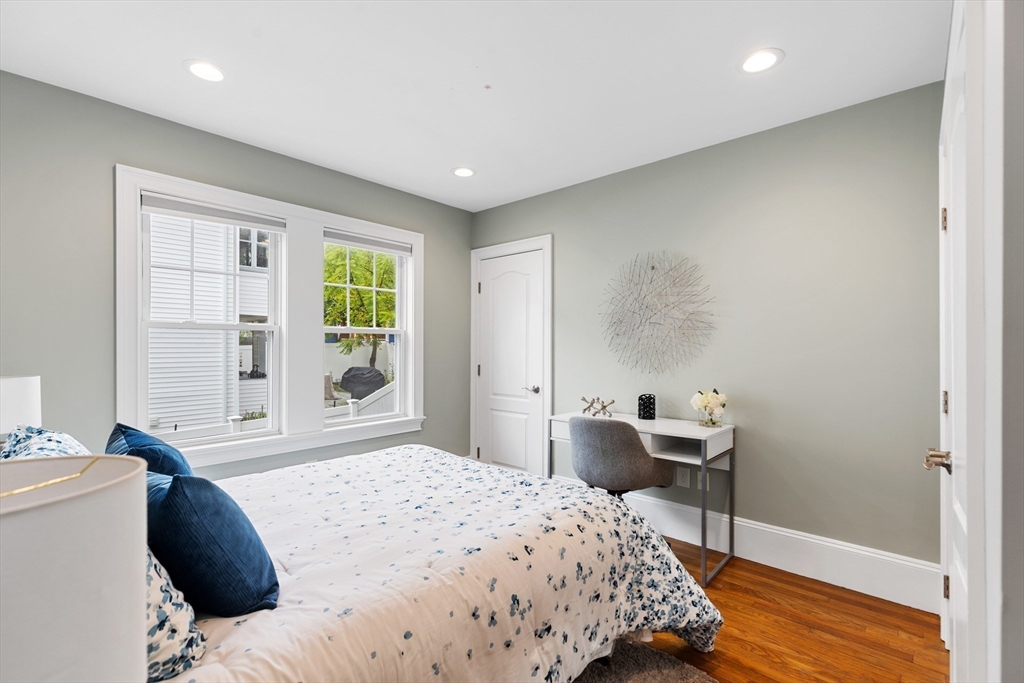 47 Fuller Road, Unit 47 Watertown, MA 02472 - Photo 12 of 21 a bedroom with a bed and wooden floor