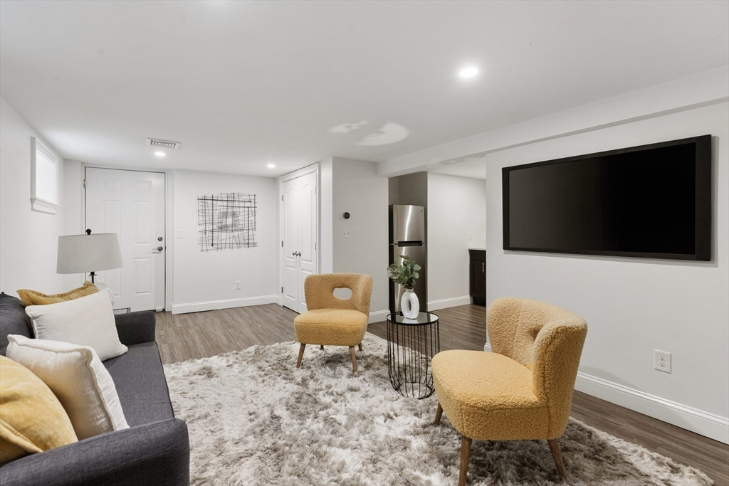 47 Fuller Road, Unit 47 Watertown, MA 02472 - Photo 14 of 21 a living room with furniture and a flat screen tv