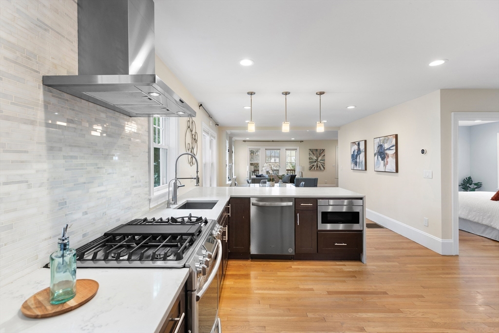 47 Fuller Road, Unit 47 Watertown, MA 02472 - Photo 5 of 21 a kitchen with stainless steel appliances granite countertop a stove a sink dishwasher and a refrigerator with wooden floor
