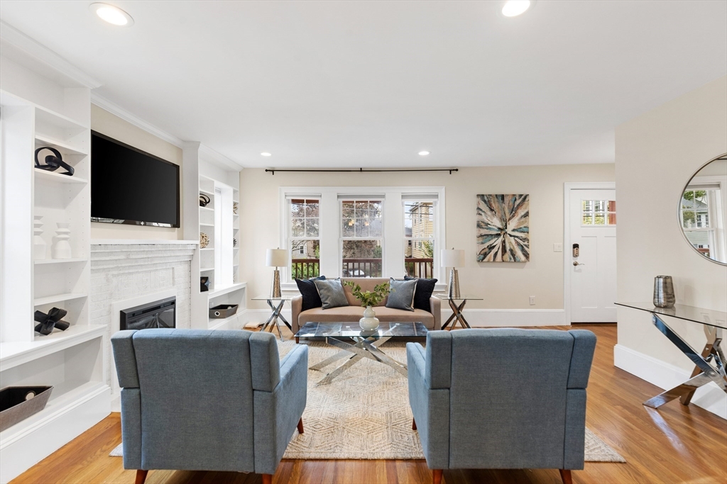47 Fuller Road, Unit 47 Watertown, MA 02472 - Photo 8 of 21 a living room with fireplace furniture and a flat screen tv