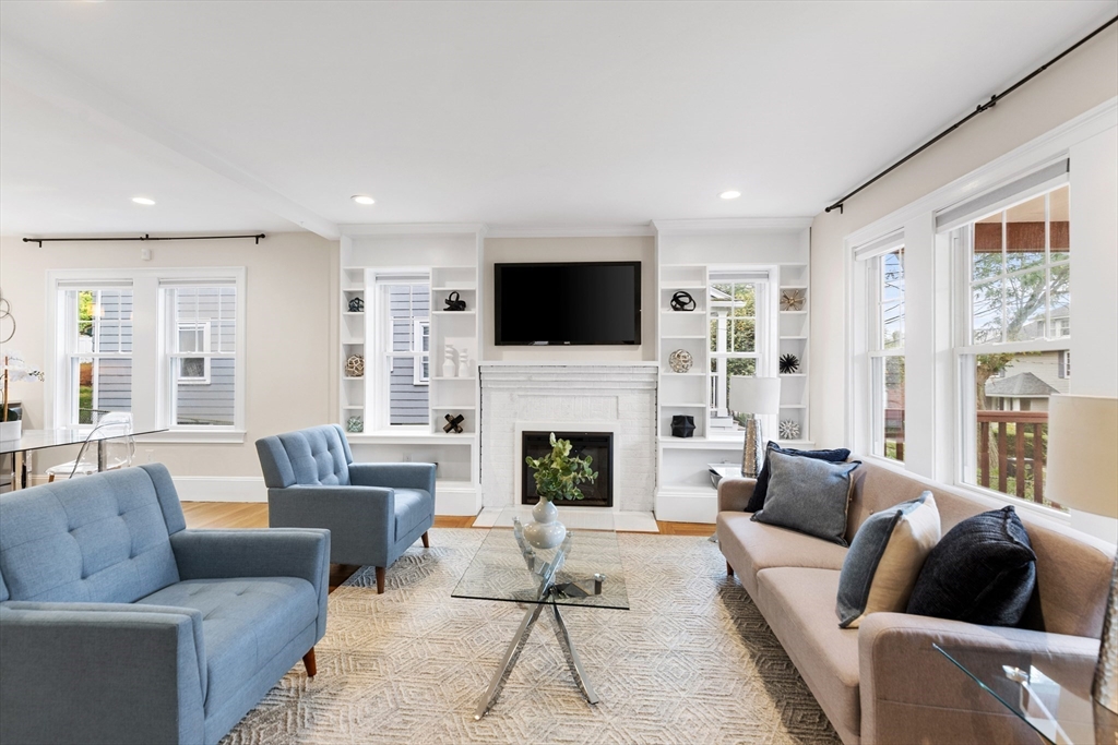 47 Fuller Road, Unit 47 Watertown, MA 02472 - Photo 9 of 21 a living room with furniture a fireplace and a flat screen tv
