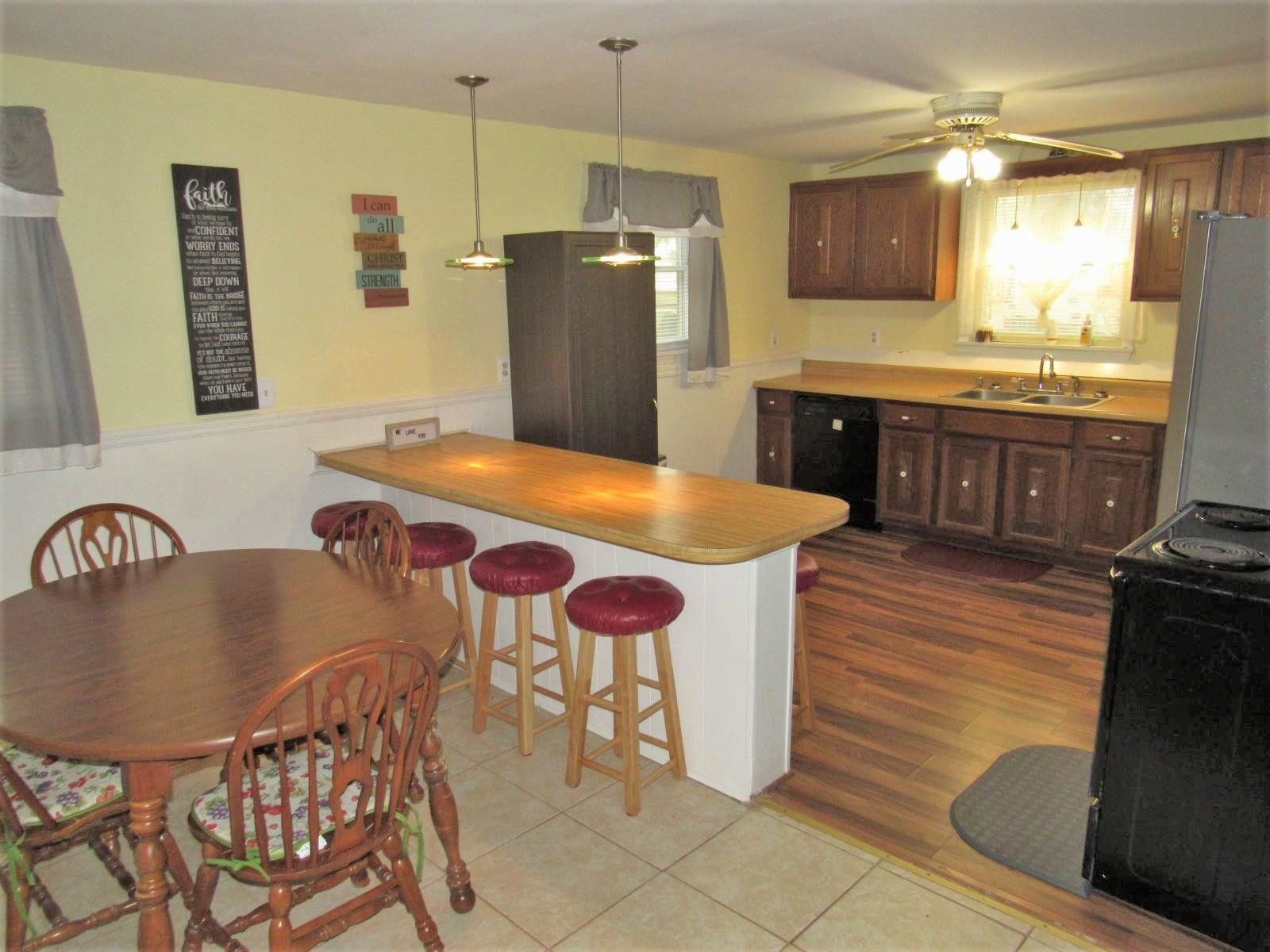 306 Waters Edge Loop Henderson, NC 27537 - Photo 13 of 35 a kitchen with stainless steel appliances granite countertop a kitchen island a stove a sink a dining table and chairs