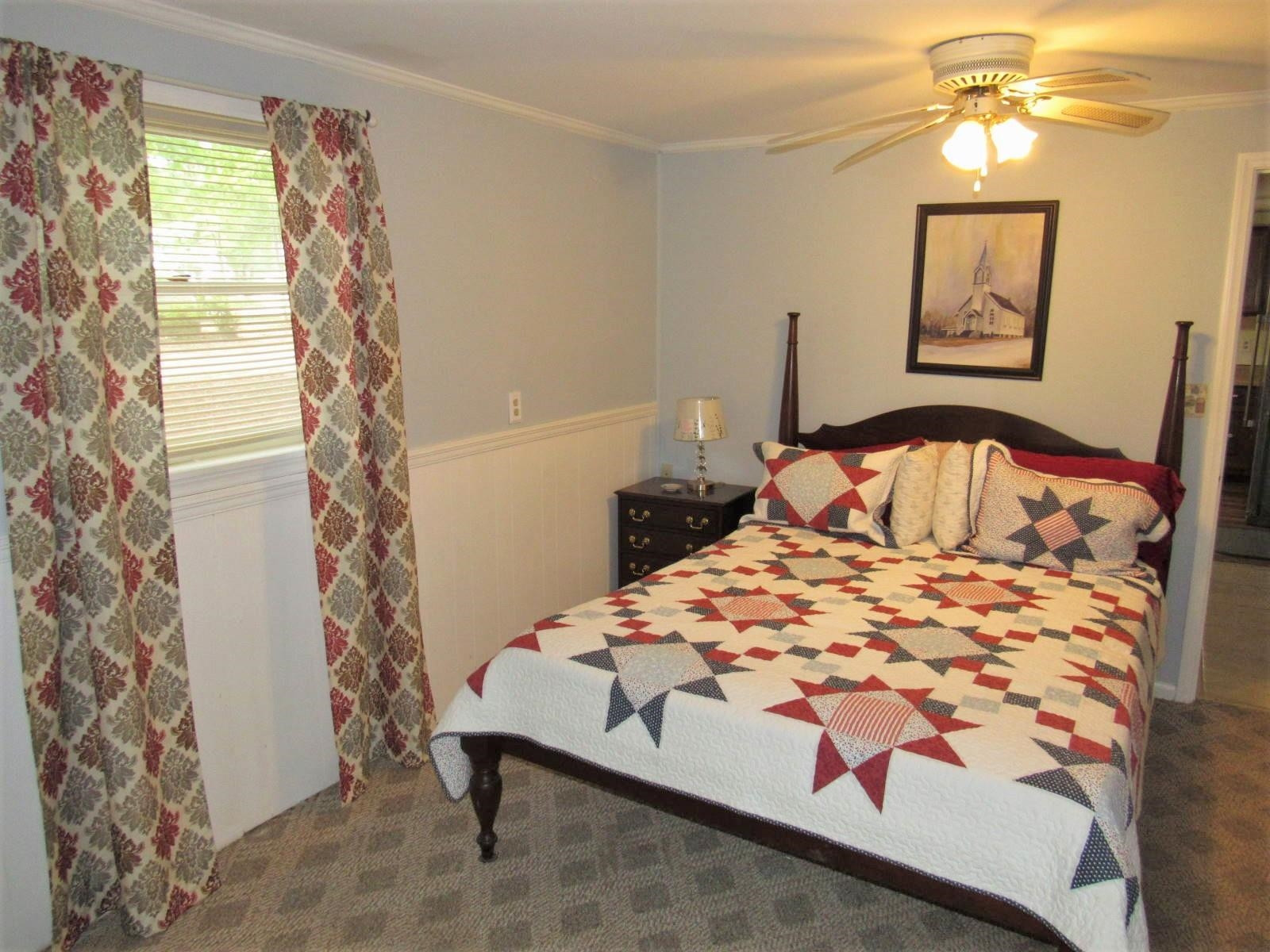 306 Waters Edge Loop Henderson, NC 27537 - Photo 16 of 35 a bedroom with a bed and a chandelier