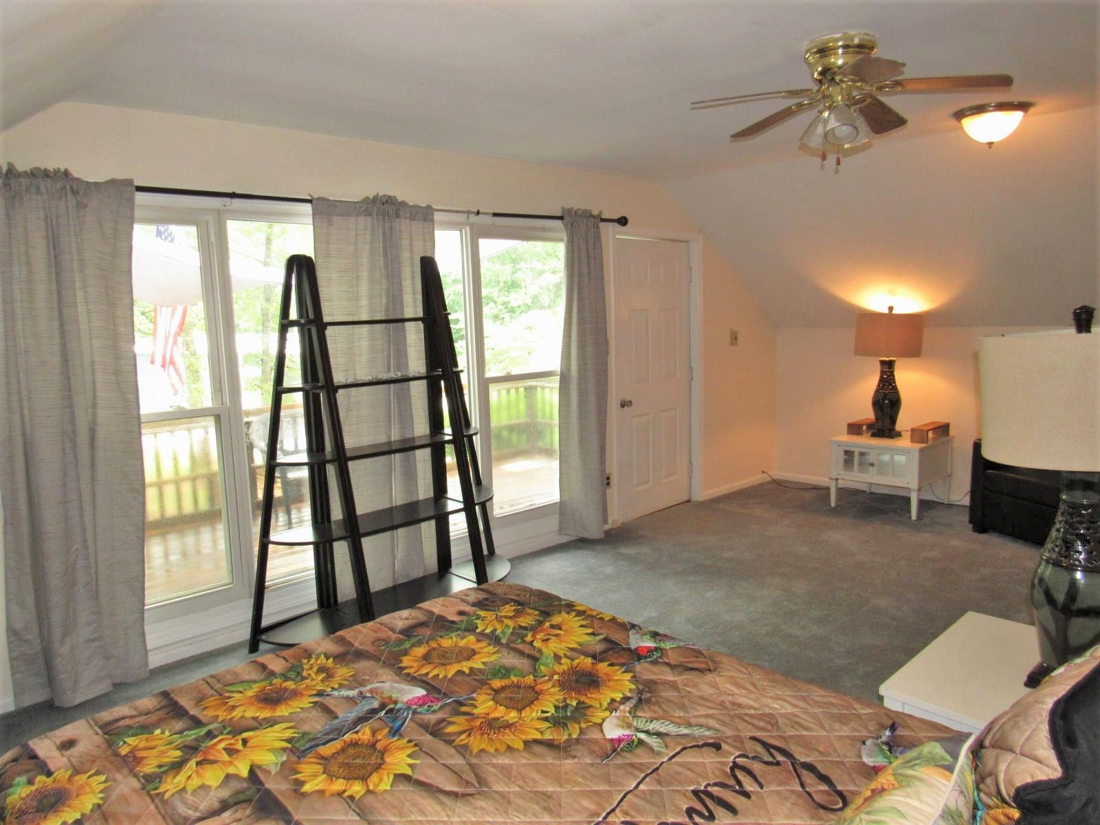 306 Waters Edge Loop Henderson, NC 27537 - Photo 18 of 35 a bedroom with a bed and a window
