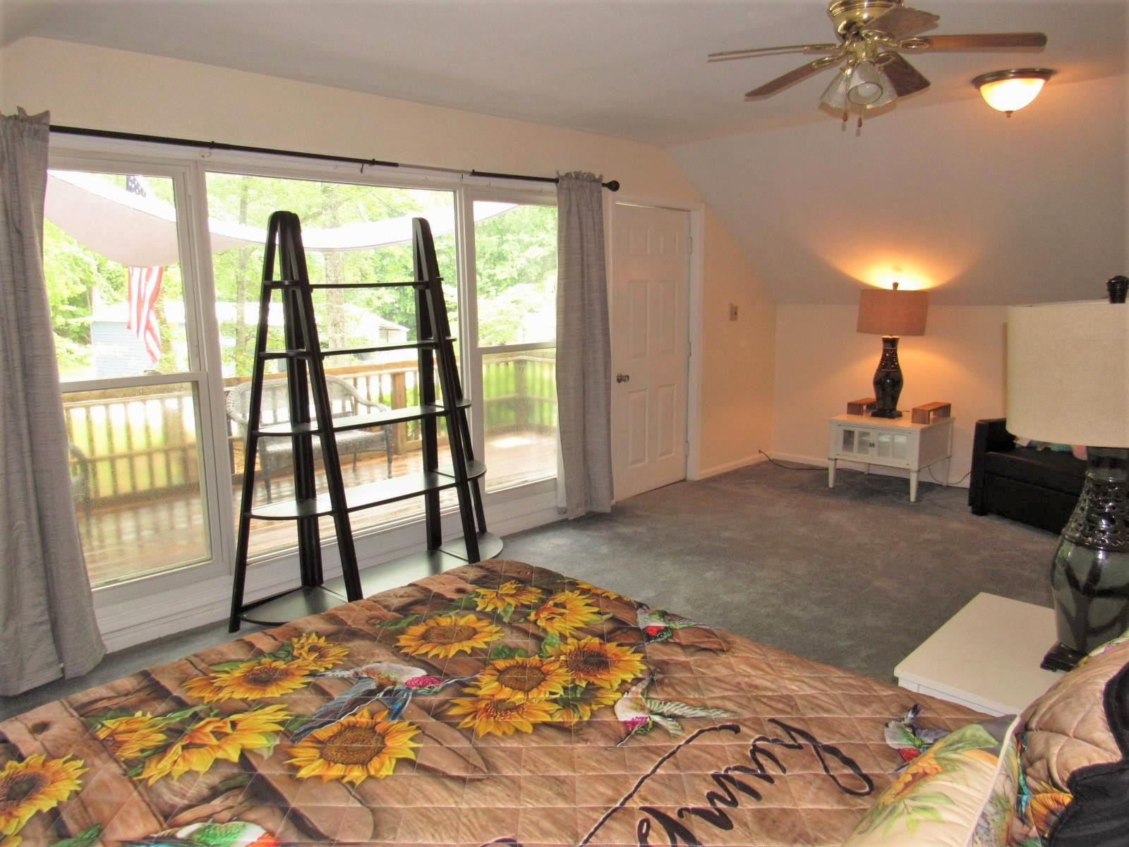 306 Waters Edge Loop Henderson, NC 27537 - Photo 19 of 35 a bedroom with a bed and a large window