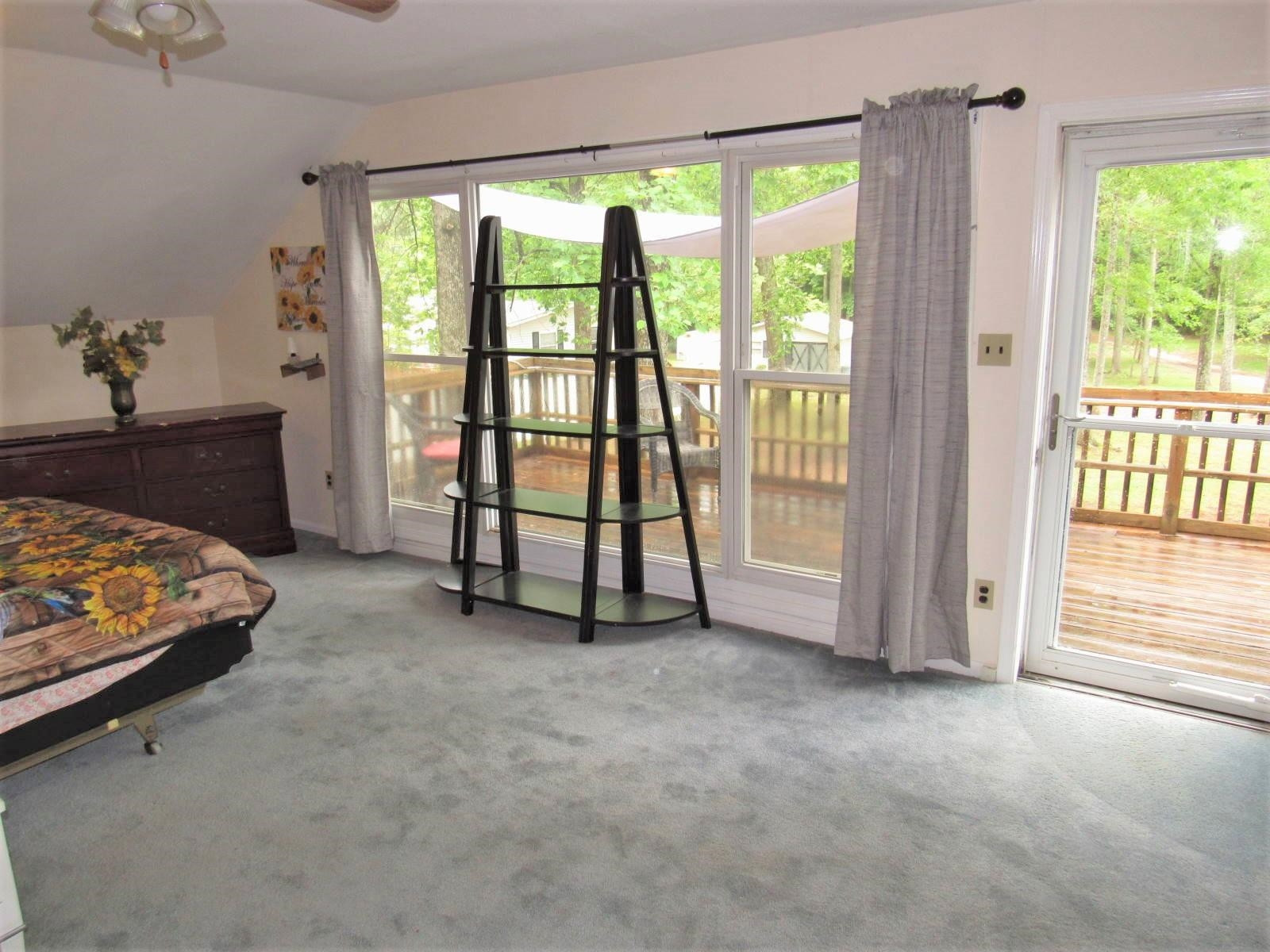 306 Waters Edge Loop Henderson, NC 27537 - Photo 20 of 35 a view of room with furniture and floor to ceiling window