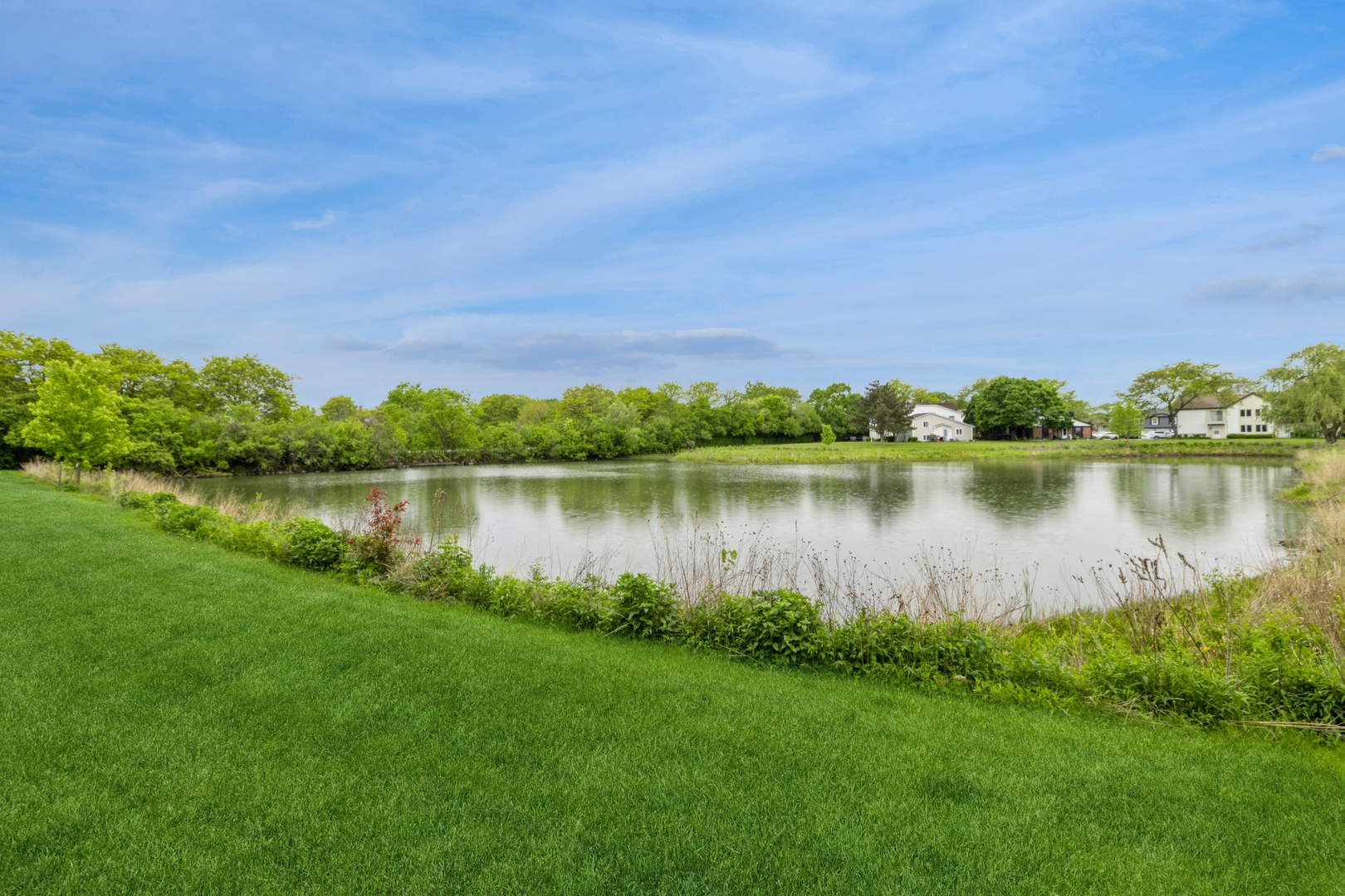 258 Inverrary Lane Deerfield, IL 60015 - Photo 13 of 13 a view of a lake with houses in the back