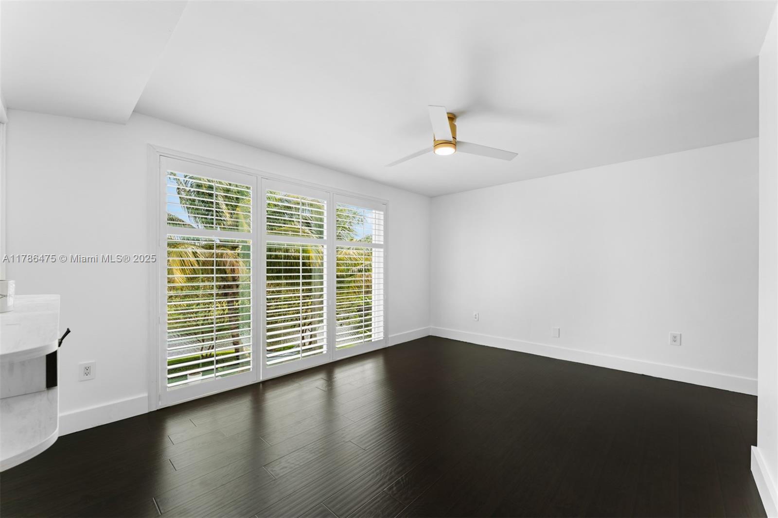 8820 Southwest 104th Street Miami, FL 33176 - Photo 23 of 44 a view of an empty room with wooden floor and a window