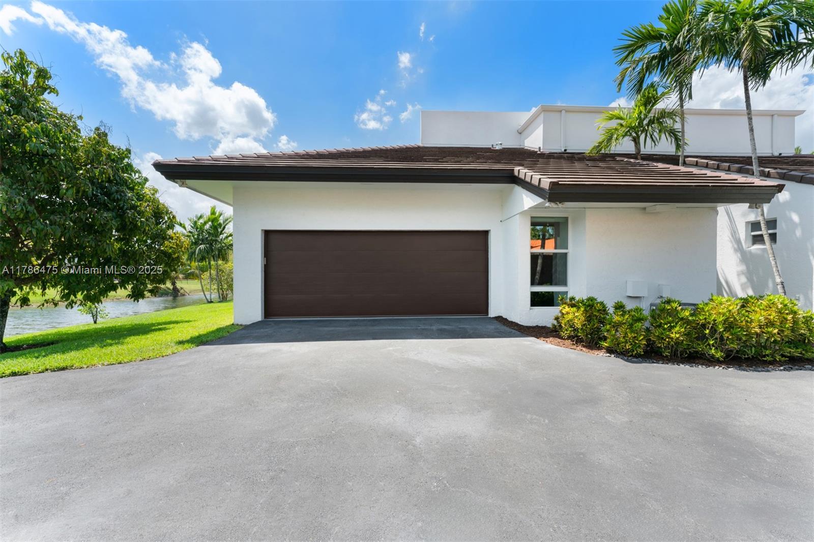 8820 Southwest 104th Street Miami, FL 33176 - Photo 32 of 44 a view of a house with a yard and garage