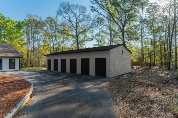 a kitchen with a sink stove and wooden floor