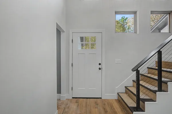 an empty room with window and ceiling fan