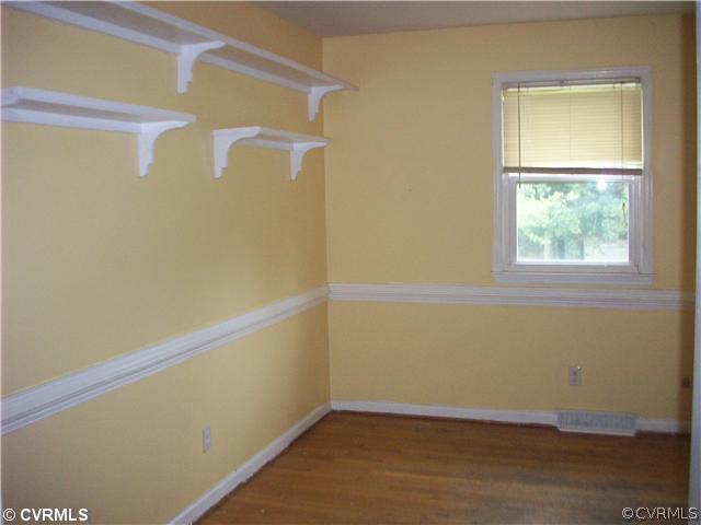 5614 Grubby Road Wilsons, VA 23894 - Photo 3 of 18 a view of a small space with wooden floor and a window