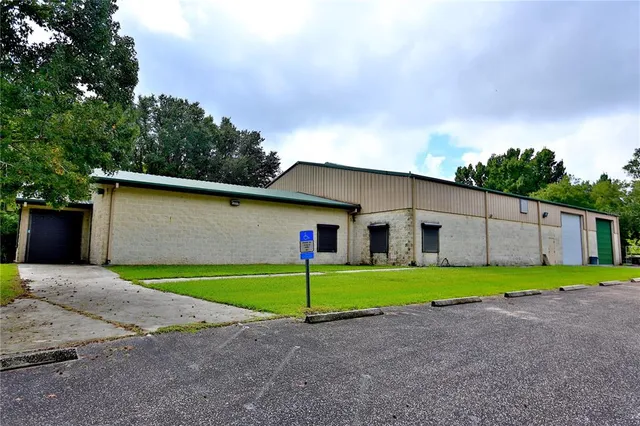 a yellow and white house with a yard