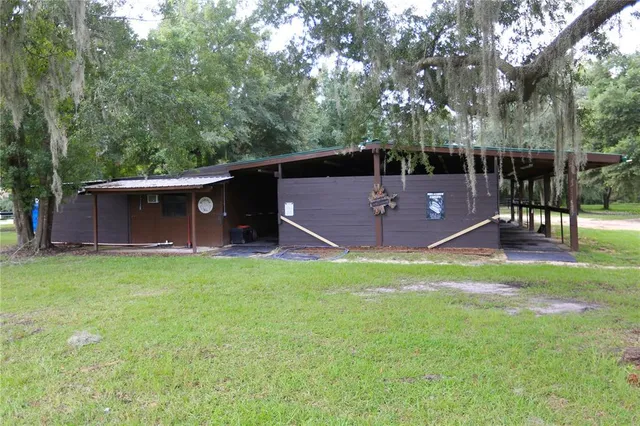 a view of a backyard with table and chairs and wooden fence