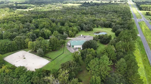 an aerial view of a house with yard