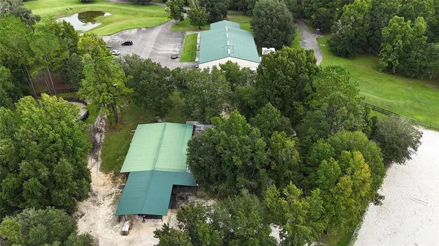 an aerial view of a house with a yard and garden