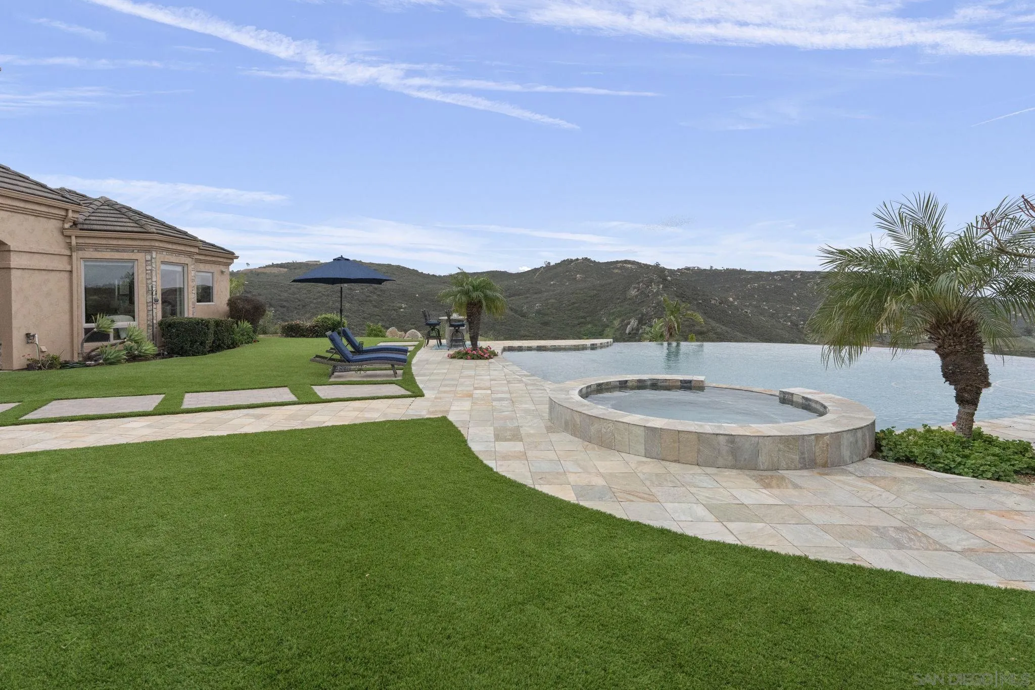 15480 Eastvale Road Poway, CA 92064 - Photo 12 of 71 a view of a patio with couches and table and chairs and potted plants