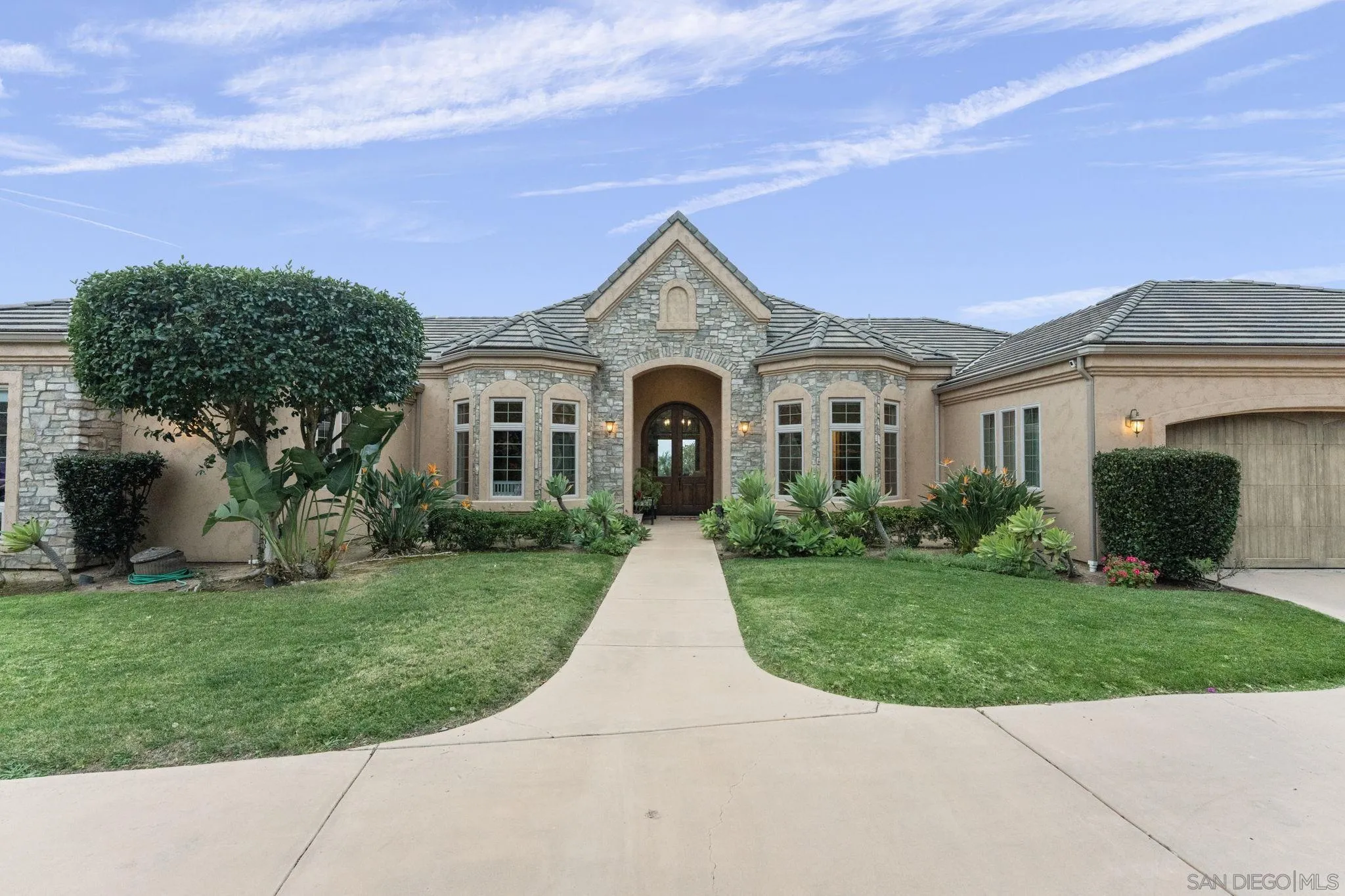 15480 Eastvale Road Poway, CA 92064 - Photo 3 of 71 a view of a brick house with a big yard plants and large trees