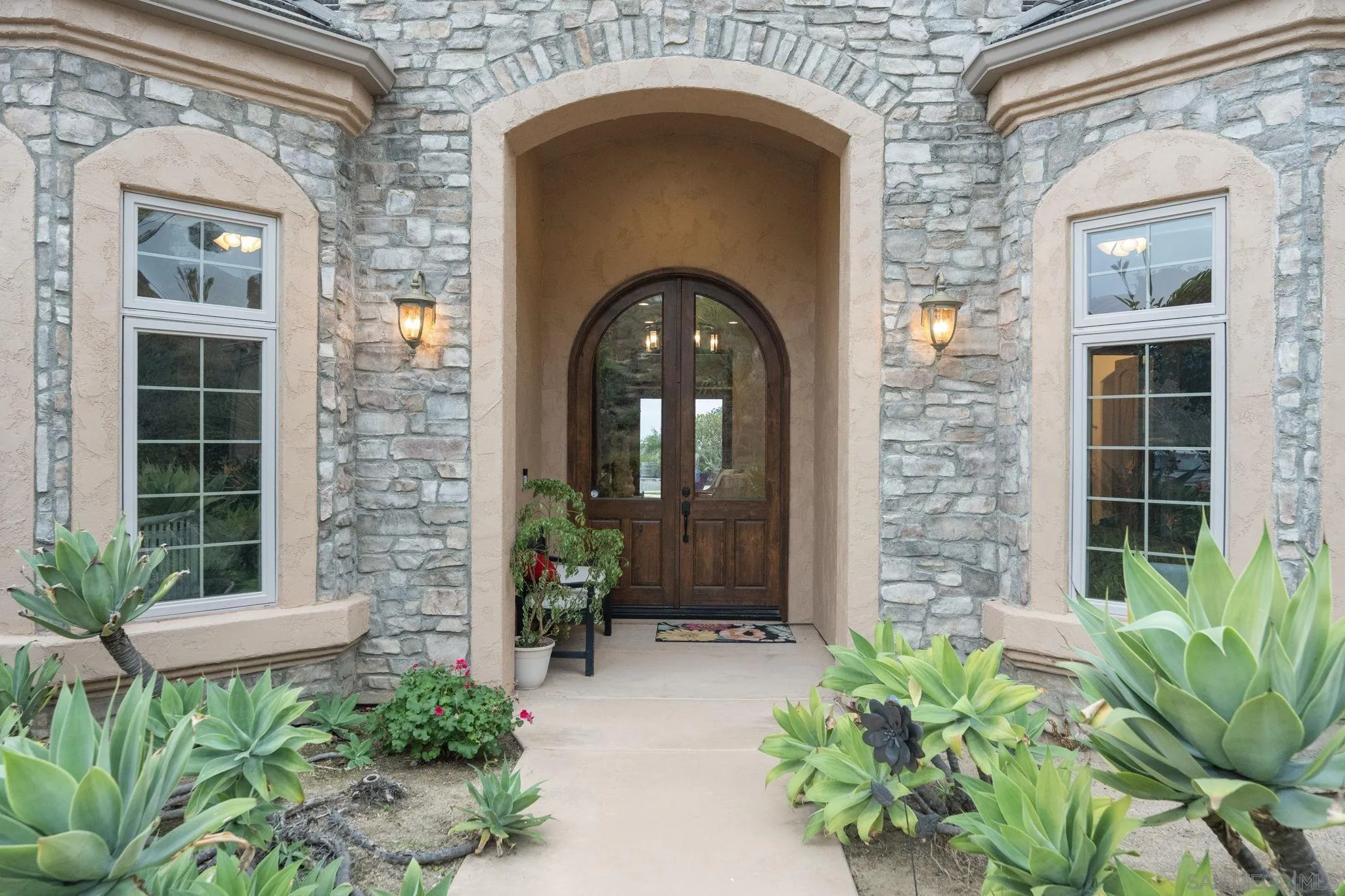 15480 Eastvale Road Poway, CA 92064 - Photo 33 of 71 a front view of a house with a garden