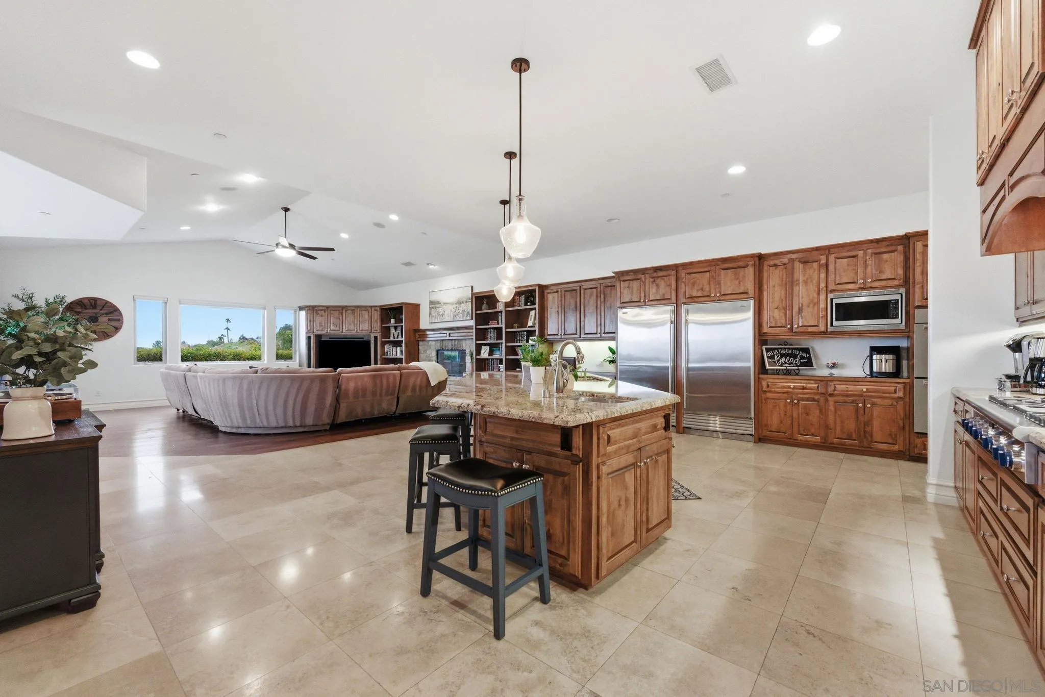 15480 Eastvale Road Poway, CA 92064 - Photo 39 of 71 a kitchen with stainless steel appliances kitchen island granite countertop a sink and a refrigerator