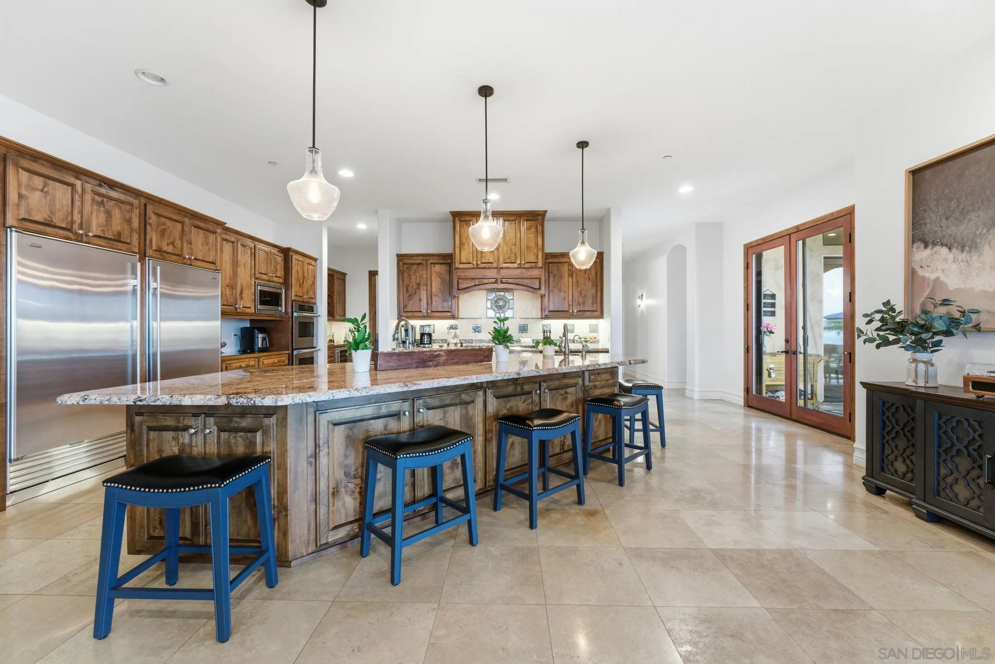 15480 Eastvale Road Poway, CA 92064 - Photo 45 of 71 a kitchen with stainless steel appliances granite countertop a kitchen island a stove and a refrigerator