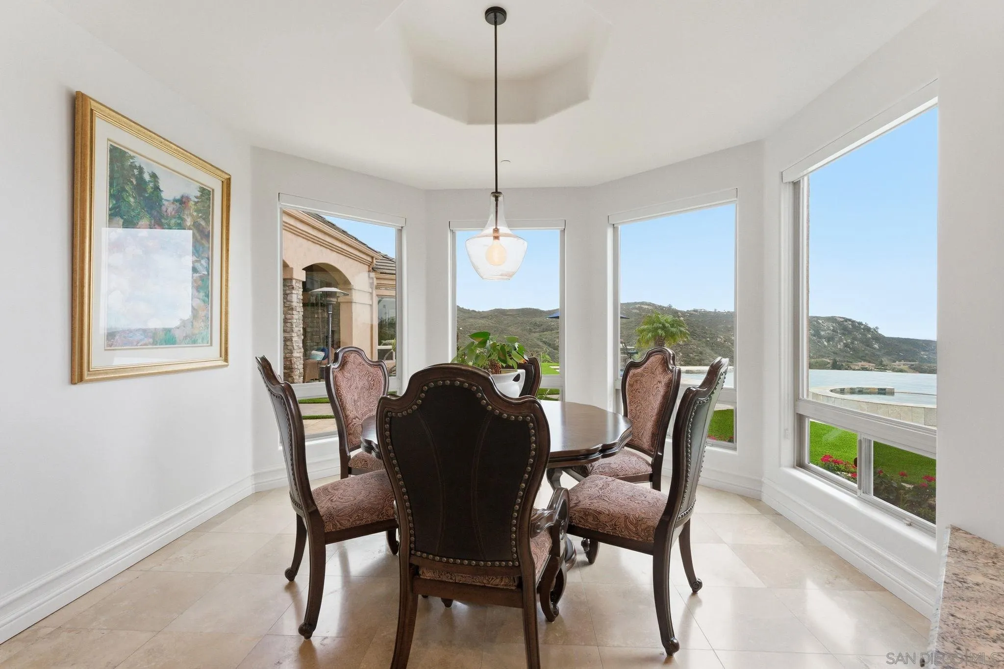 15480 Eastvale Road Poway, CA 92064 - Photo 48 of 71 a dining room with furniture a chandelier and wooden floor