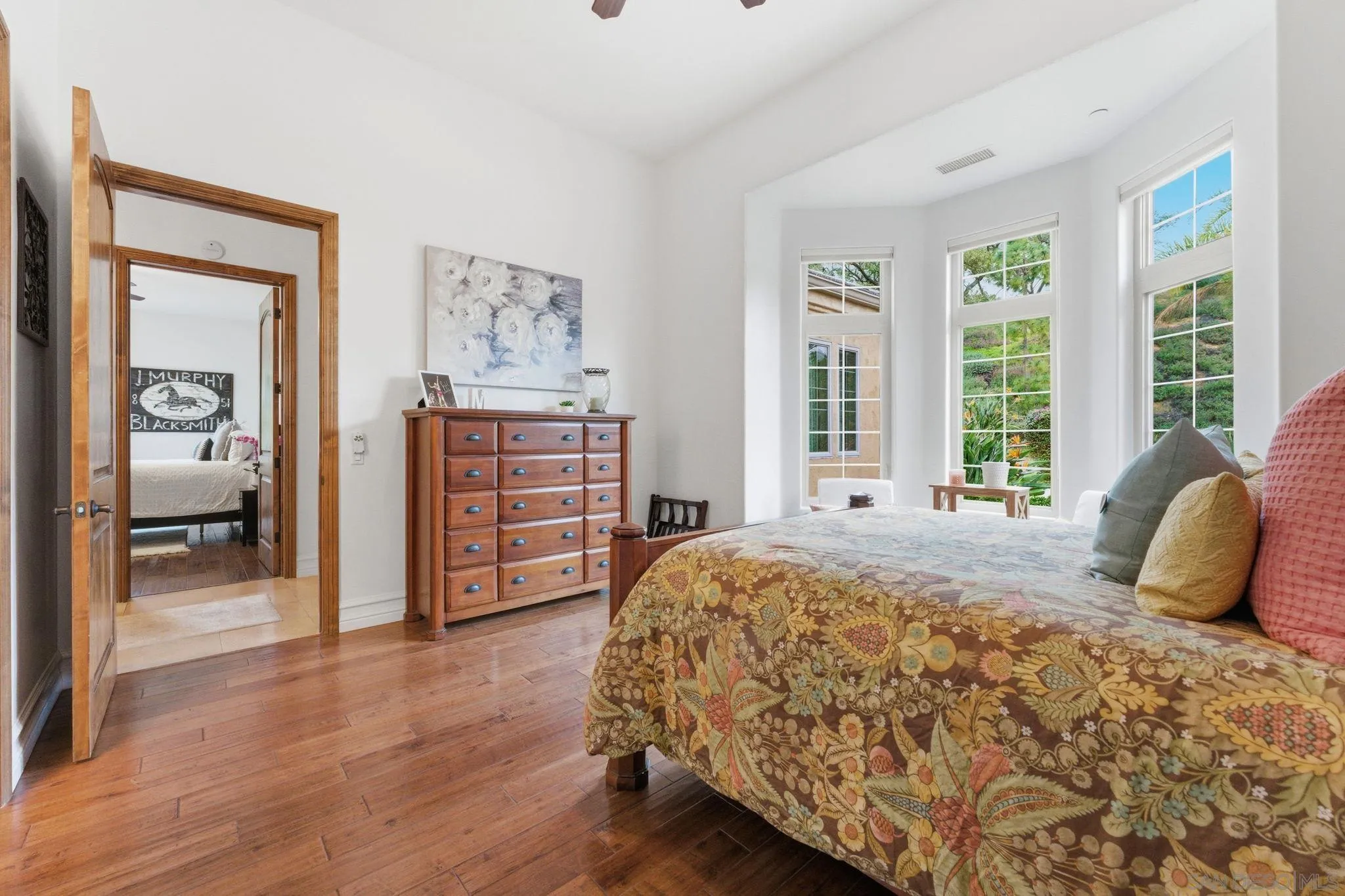 15480 Eastvale Road Poway, CA 92064 - Photo 55 of 71 a bedroom with a bed and wooden floor