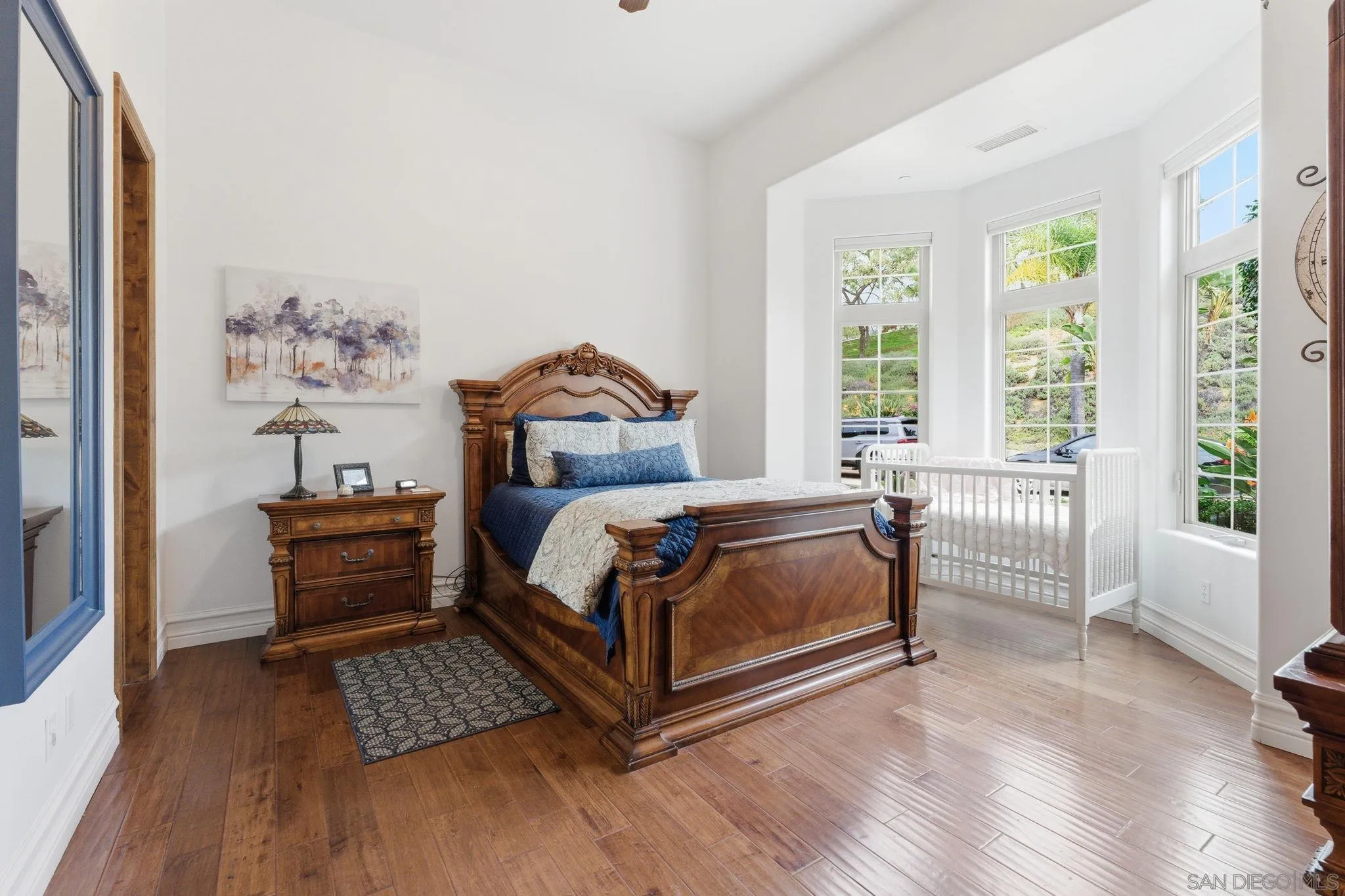 15480 Eastvale Road Poway, CA 92064 - Photo 56 of 71 a bedroom with a bed and wooden floor