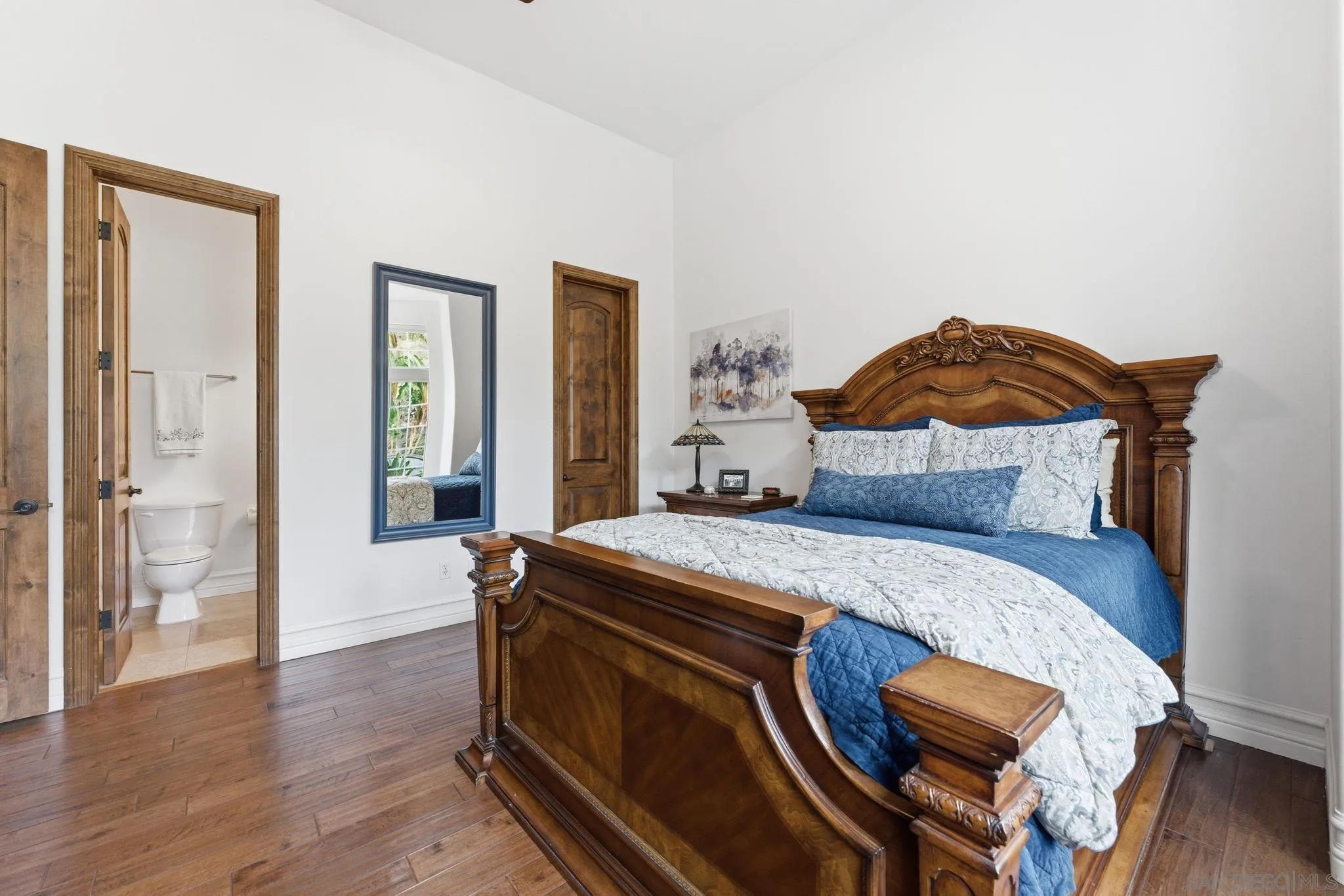 15480 Eastvale Road Poway, CA 92064 - Photo 57 of 71 a bedroom with a bed and wooden floor