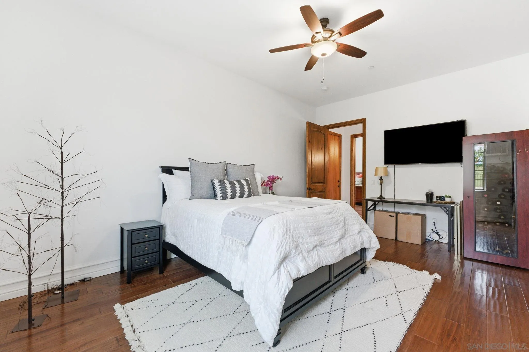 15480 Eastvale Road Poway, CA 92064 - Photo 59 of 71 a bedroom with a bed and a flat screen tv