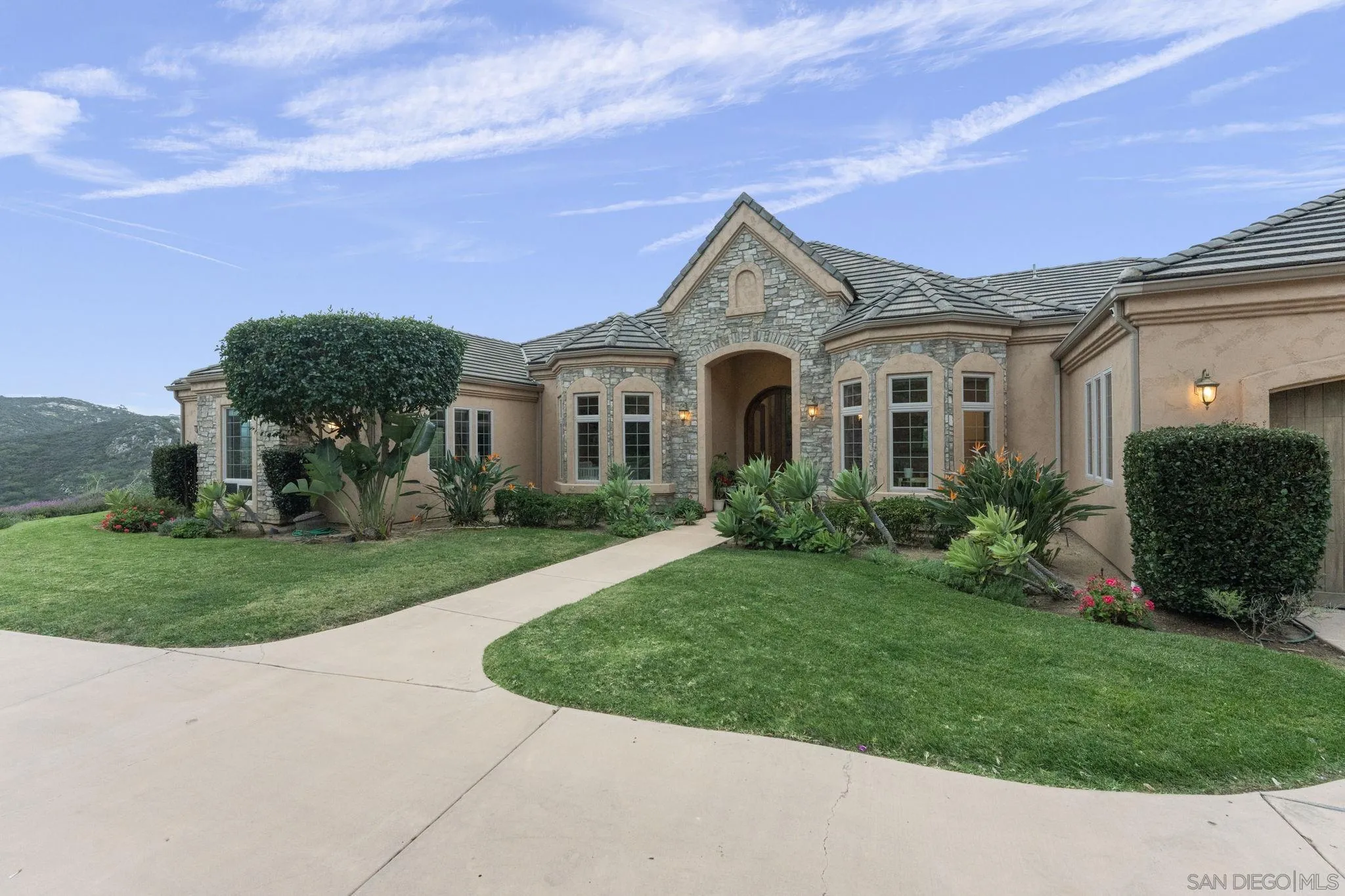 15480 Eastvale Road Poway, CA 92064 - Photo 6 of 71 a front view of a house with a yard