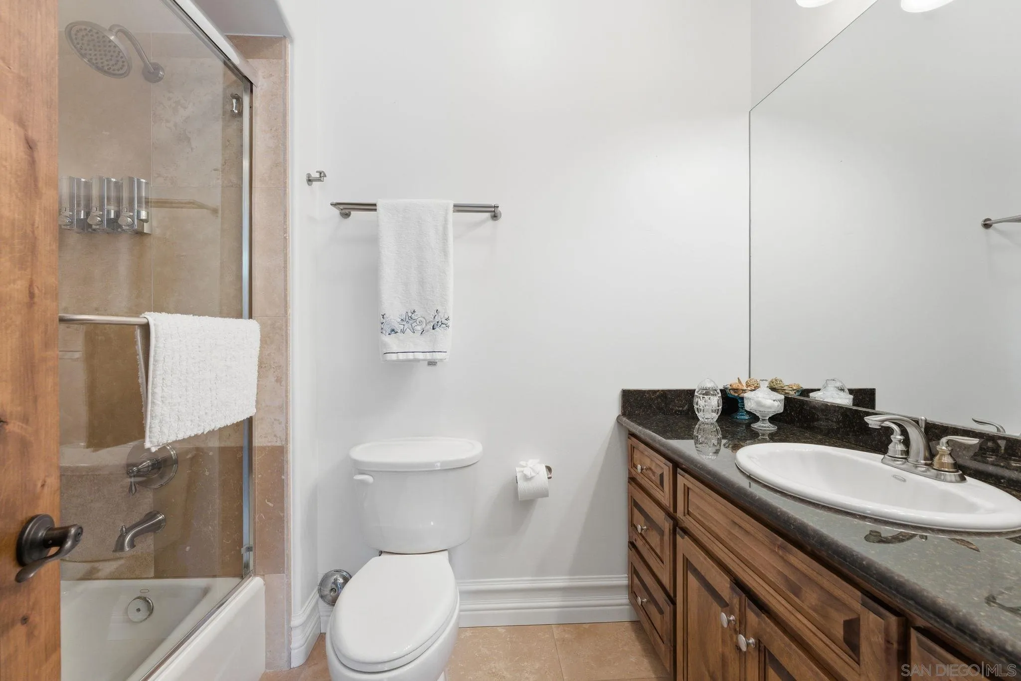 15480 Eastvale Road Poway, CA 92064 - Photo 66 of 71 a bathroom with a granite countertop sink toilet and shower