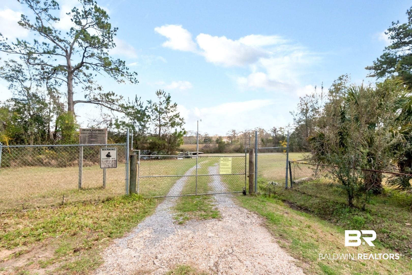 11528 Mocking Bird Lane Fairhope, AL 36532 - Photo 36 of 45 View of dirt / gravel driveway featuring a gate and a gated entry