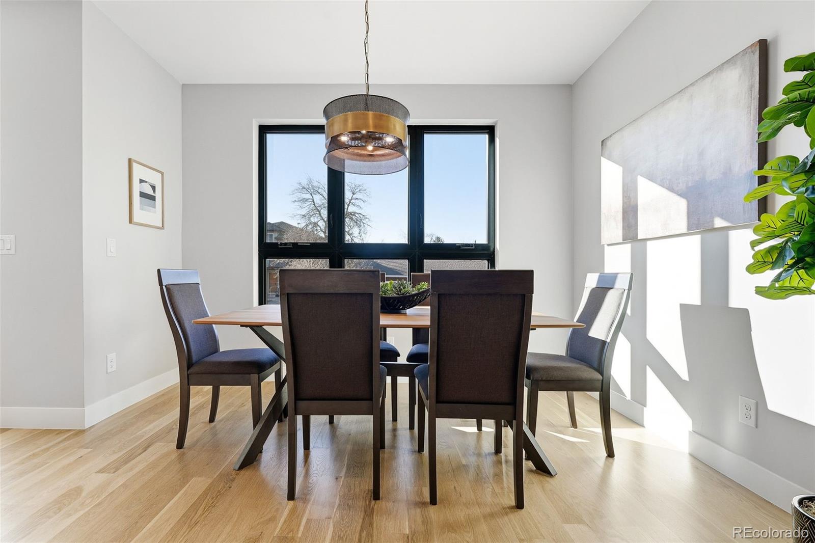 2186 South Sherman Street Denver, CO 80210 - Photo 11 of 44 a view of a dining room with furniture window and wooden floor