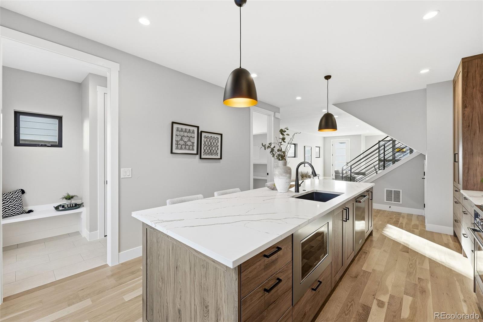 2186 South Sherman Street Denver, CO 80210 - Photo 14 of 44 a kitchen with a sink a stove and a wooden floors