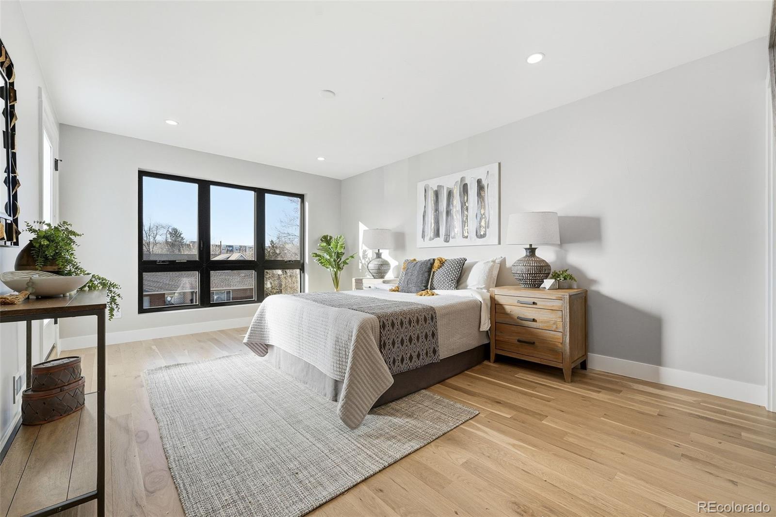 2186 South Sherman Street Denver, CO 80210 - Photo 18 of 44 a bedroom with a bed and a large window