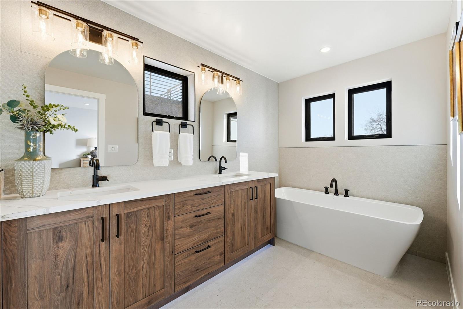 2186 South Sherman Street Denver, CO 80210 - Photo 19 of 44 a bathroom with a double vanity sink mirror and bathtub