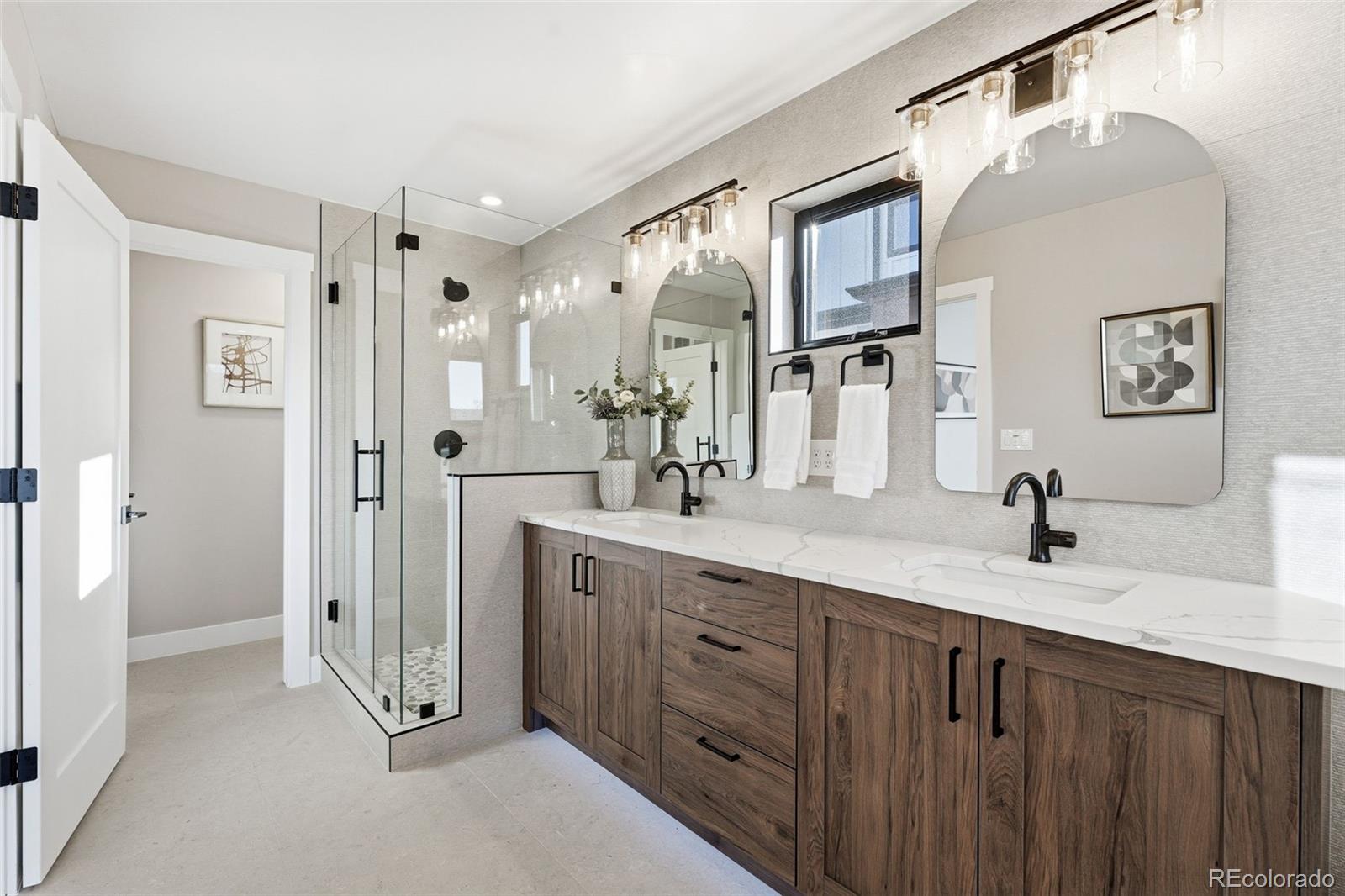 2186 South Sherman Street Denver, CO 80210 - Photo 20 of 44 a spacious bathroom with a double vanity sink shower and a mirror