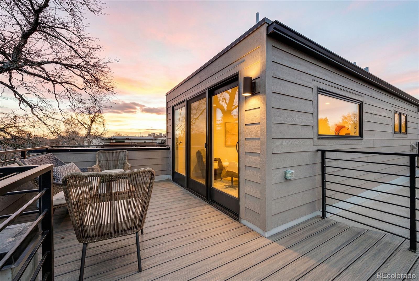 2186 South Sherman Street Denver, CO 80210 - Photo 25 of 44 a view of a roof deck with wooden floor and fence