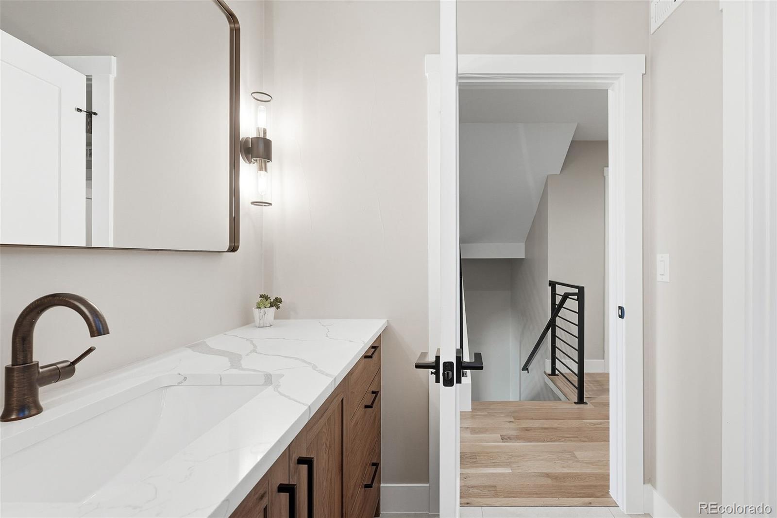 2186 South Sherman Street Denver, CO 80210 - Photo 28 of 44 a bathroom with a sink and mirror