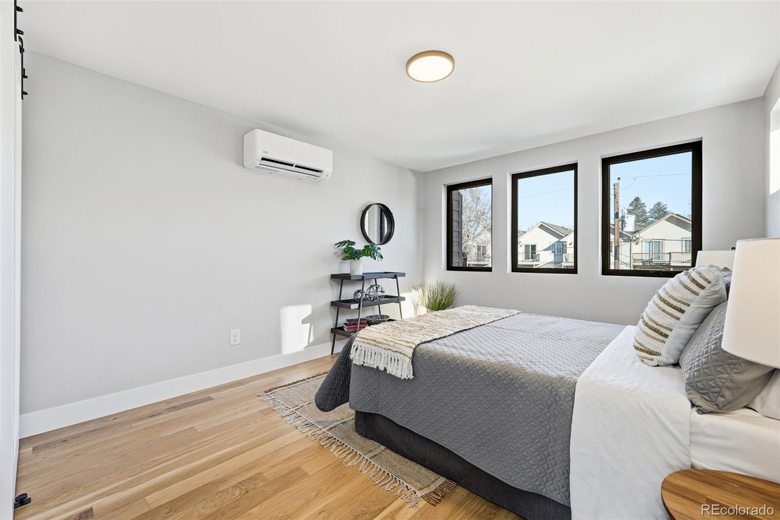 2186 South Sherman Street Denver, CO 80210 - Photo 30 of 44 a bedroom with a bed and wooden floor