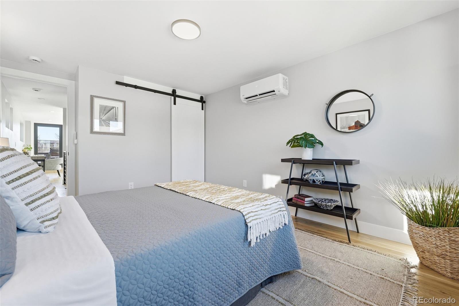 2186 South Sherman Street Denver, CO 80210 - Photo 32 of 44 a bedroom with a bed and paintings on the wall