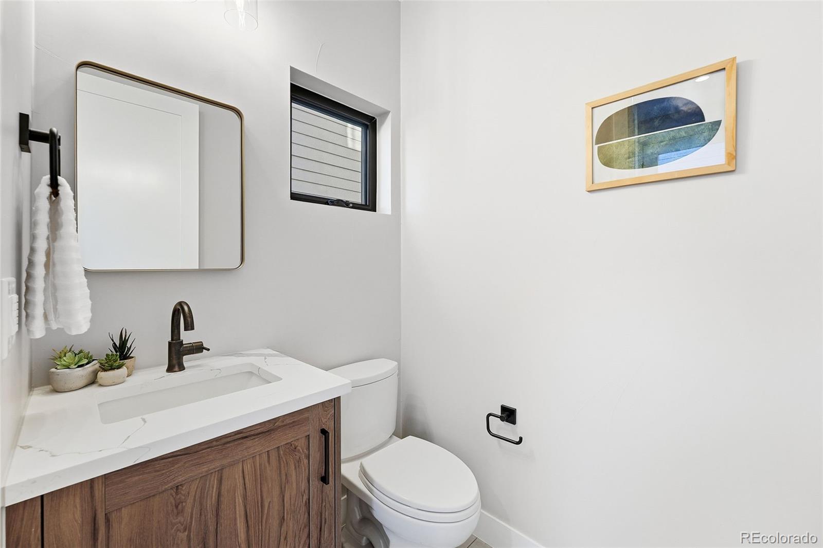 2186 South Sherman Street Denver, CO 80210 - Photo 38 of 44 a bathroom with a toilet a sink and mirror