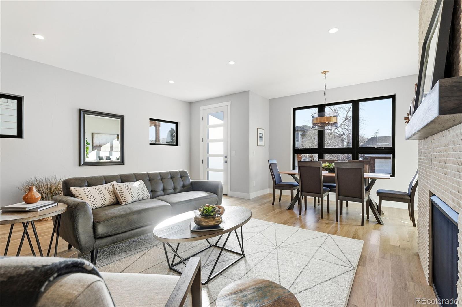 2186 South Sherman Street Denver, CO 80210 - Photo 9 of 44 a living room with furniture wooden floor and a floor to ceiling window