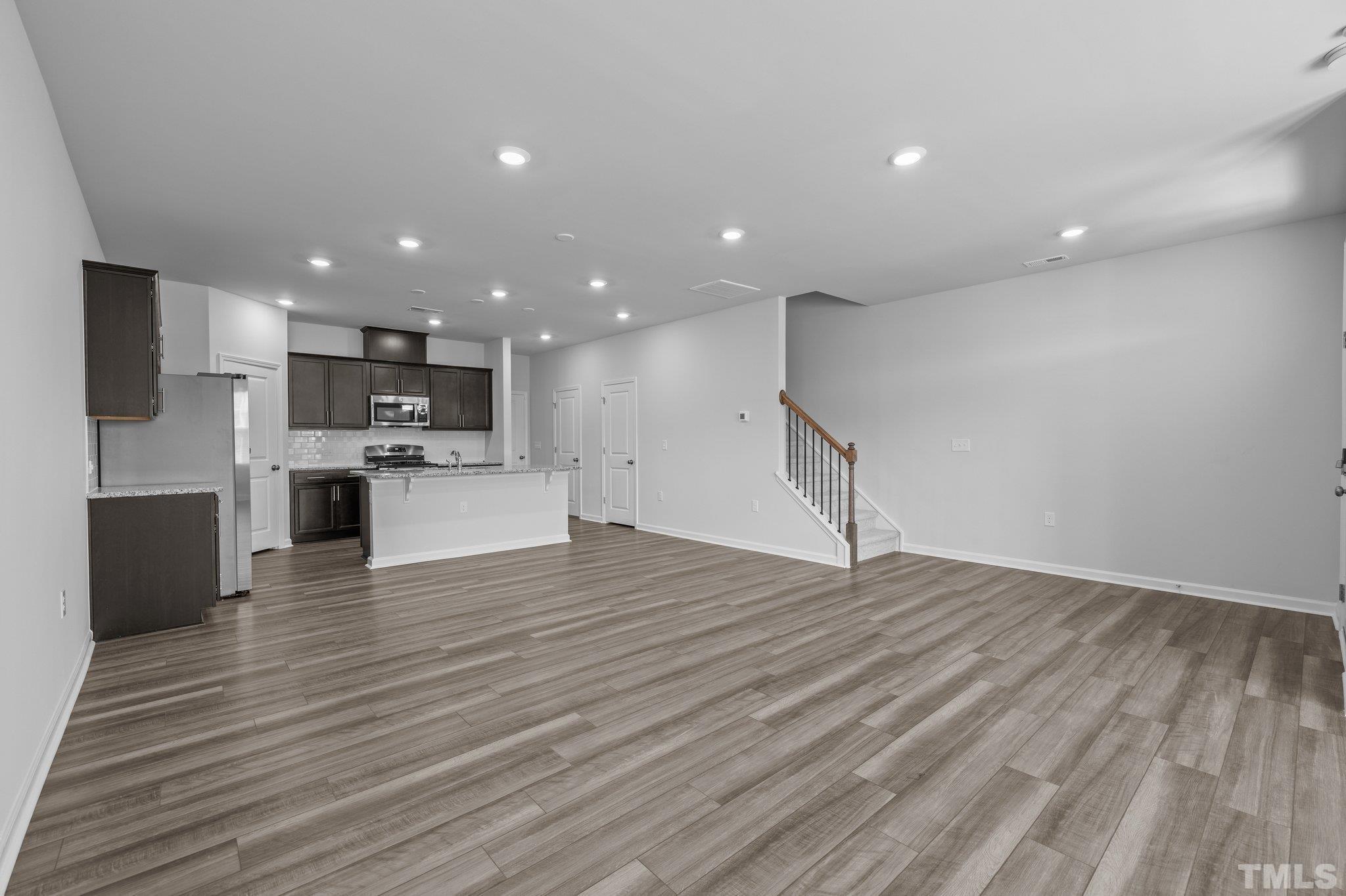 5106 Anamosa Street Raleigh, NC 27610 - Photo 18 of 49 a view of kitchen with kitchen island microwave and stove