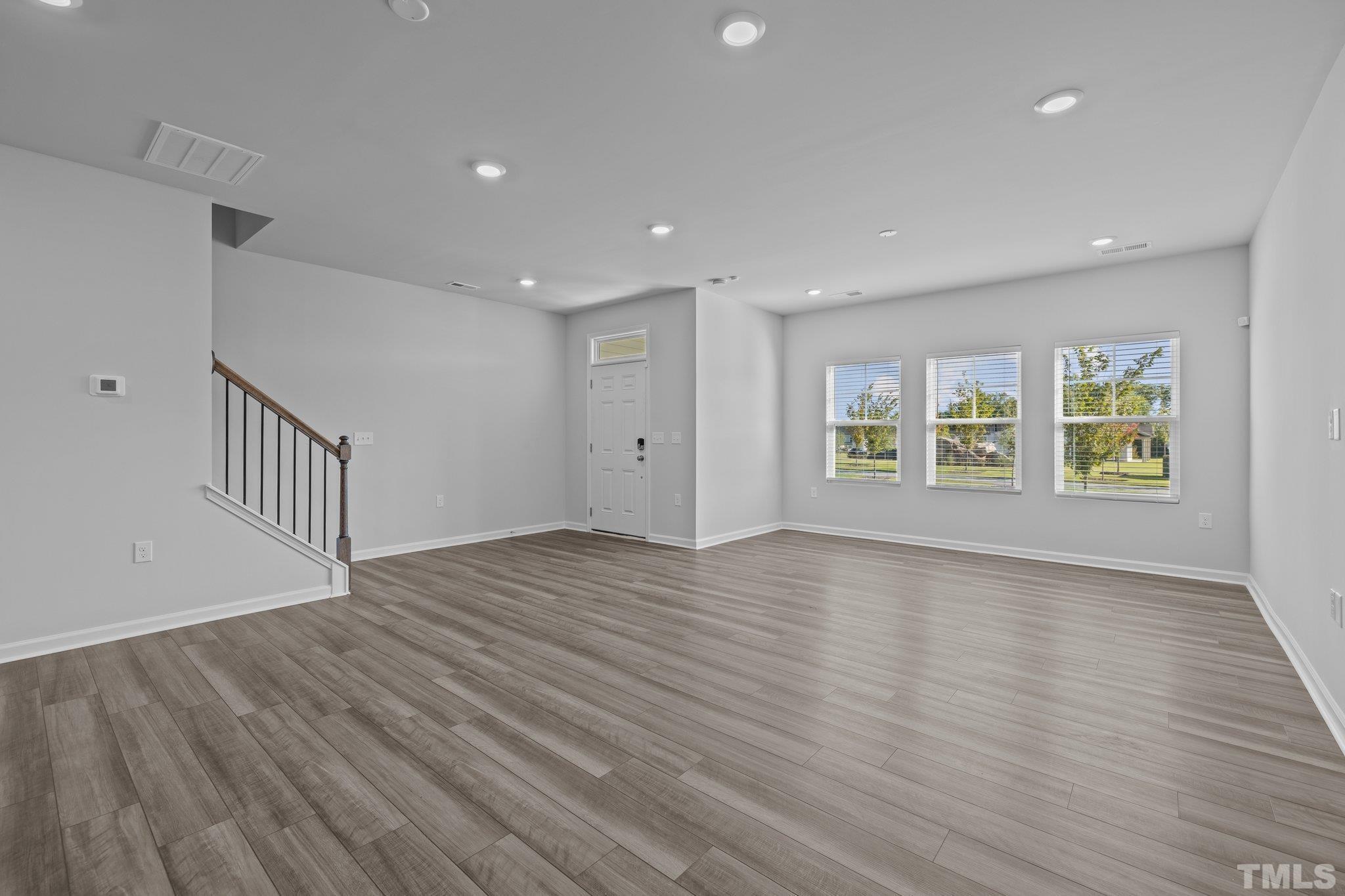 5106 Anamosa Street Raleigh, NC 27610 - Photo 19 of 49 a view of an empty room with wooden floor and a window