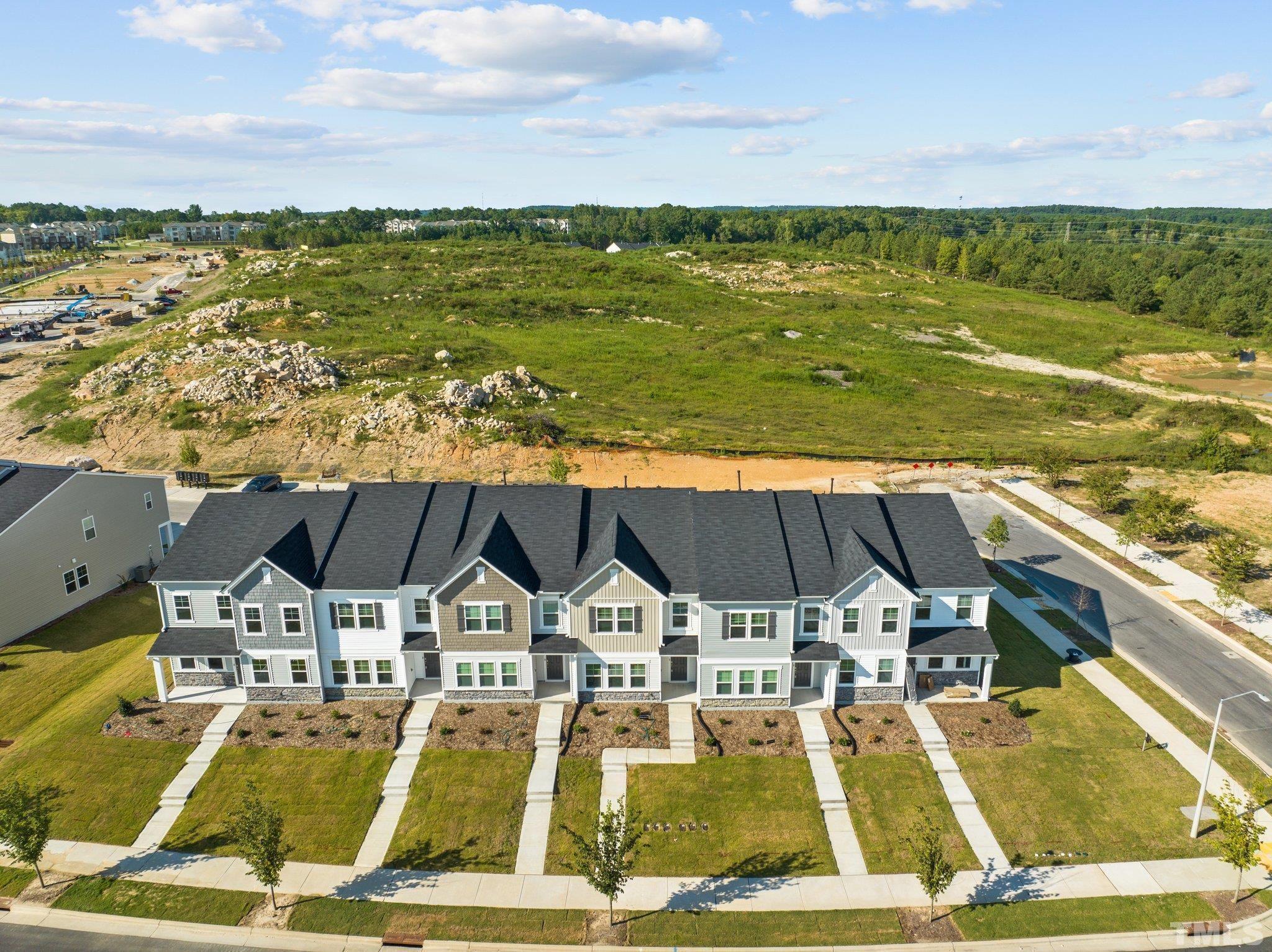 5106 Anamosa Street Raleigh, NC 27610 - Photo 30 of 49 a view of a patio with lawn chairs under an umbrella