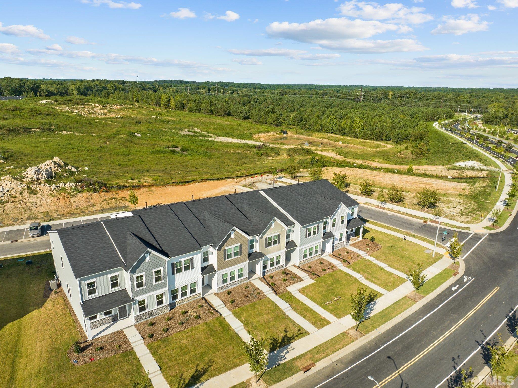 5106 Anamosa Street Raleigh, NC 27610 - Photo 31 of 49 a view of a swimming pool with a table and chairs under an umbrella