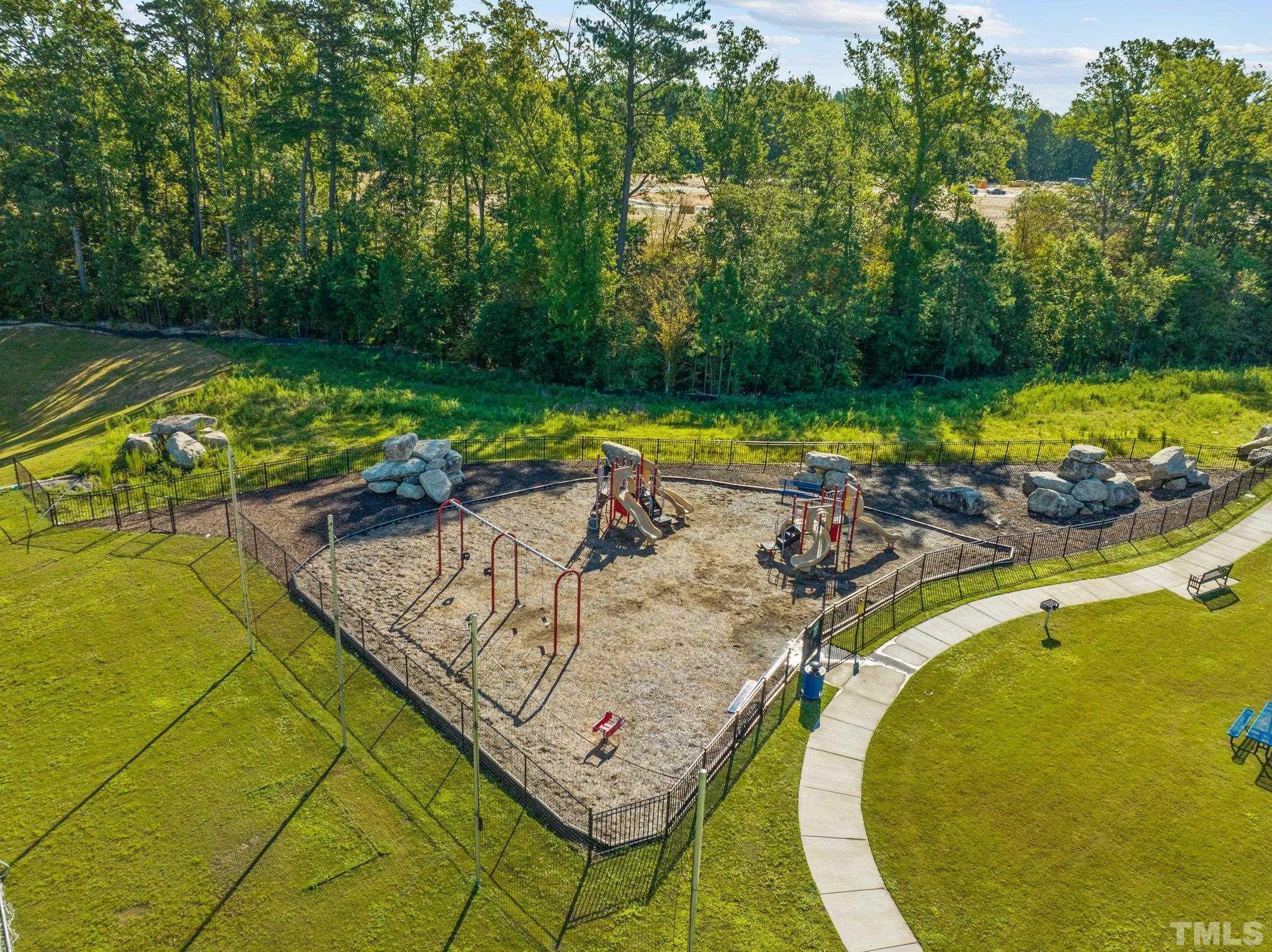 5106 Anamosa Street Raleigh, NC 27610 - Photo 36 of 49 a view of a swimming pool with a patio and garden